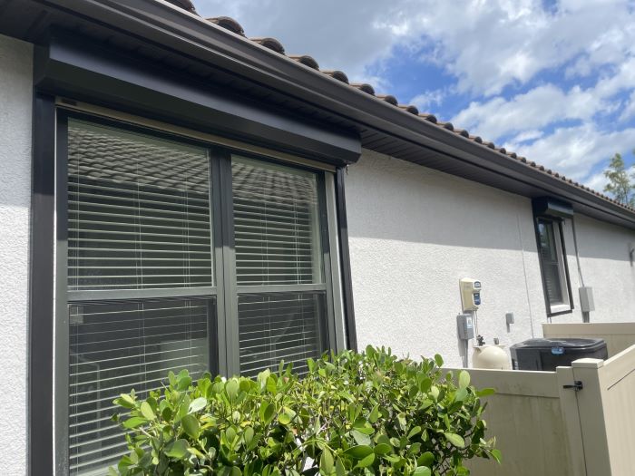 Motorized hurricane shutters protecting Ave Maria FL home with convenient remote control operation